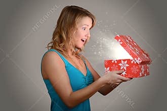 Young woman with magic christmas gift