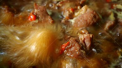 Boiling pork soup in pot, in door Chiangmai Thailand.