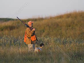 Hunter with his dog in the early morning