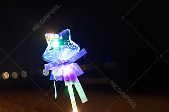 Colorful fluorescent light neon glow star shape stick on a sky black background