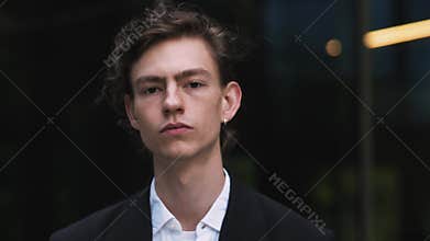 Portrait serious exhausted business man at street. Tired businessman near modern office. Unhappy man looking away at