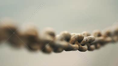 chain fencing. hanging thick forged metal chain. large weave. close-up of the fence on the pier