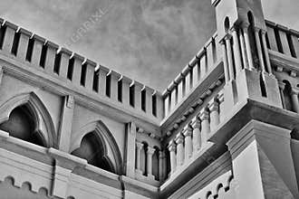 retro style stone castle or fort wall closeup. turret and old style arched openings