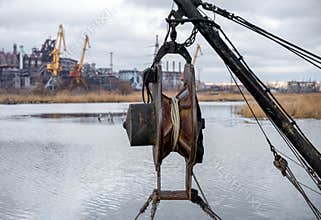 ship equipment against the background of the destroyed Azovstal plant in Ukraine