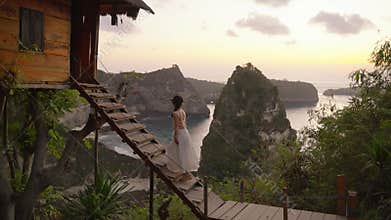 Nusa penida, Bali, indonesia, 4K video of woman white dress walking of tree house