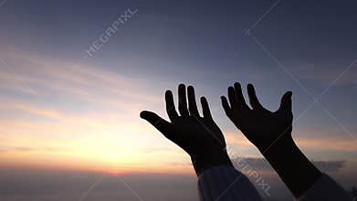 A woman raises her palms in prayer. Religious belief and belief in Jesus Christ Blessings, help, hope, faith, love and loyalty