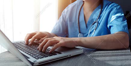 Attractive female doctor make online video call consult patient on laptop. Medical assistant young woman therapist