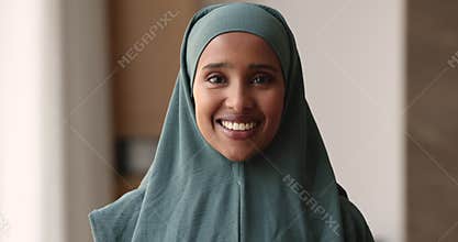 Headshot portrait Somalian woman in hijab smile look at camera