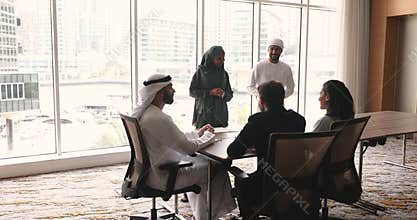 Multicultural team communicate in modern board room
