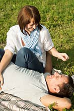 Young man and woman having fun at summer picnic