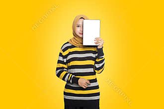 portrait of beautiful Muslim woman wearing hijab showing off digital computer tablet.