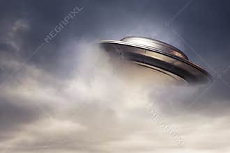 Big UFO emerging from the clouds