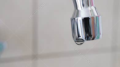 Water saving. Dripping faucet, waste of water.