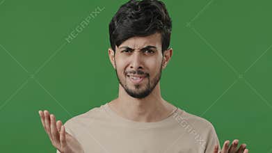 Dissatisfied shocked young man 20s guy wears casual shirt bemused asks what show displeased emotion swing hands feels