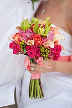 Hand holds bridal bouquet