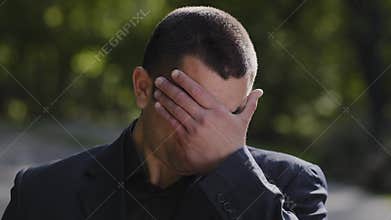 Outdoors portrait sad caucasian hispanic adult 30s business man feel exhaustion stress worry massaging dry irritable