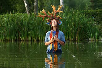 Portrait of the teenage Girl wearing brown yellow felted Bambi hat