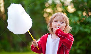 Llittle girl eating cotton candy