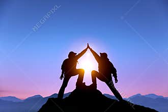 Two man with success gesture on the mountain
