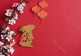 Chinese New Year, year of the rabbit. Year 2023 with golden rabbit and plum blossom fans. Copy space.
