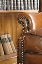 Old leather chair and wooden bookcase