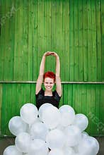 Red hair girl with silver balloons