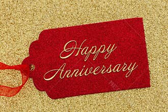 Happy Anniversary greeting red gift tag on gold