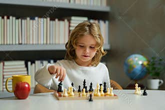 Little child play chess. Kid playing board game. Thinking child brainstorming and idea in chess game. Chess school and