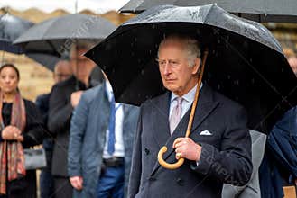 close up portrait of the British king Charles III. under an umbrella during the state vivit in Hamburg