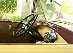 Old time yellow car steering wheel and dash board