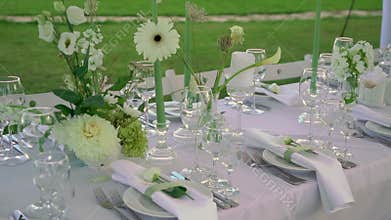 Served tables for a holiday in a restaurant. Glasses, plates, cutlery, napkins.