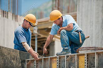 Construction workers installing formwork frames