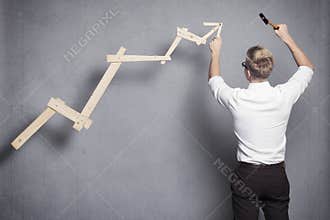 Businessman building business graph.