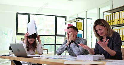 Frustrated frustrated people from business team are studying negative business statistics