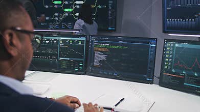IT technical specialist and team of software programmer work in monitoring office