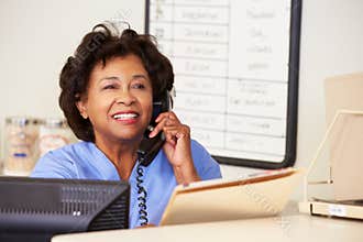 Nurse Making Phone Call At Nurses Station