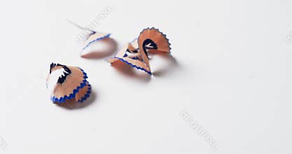 Close up of blue crayon shavings with copy space on white background, in slow motion