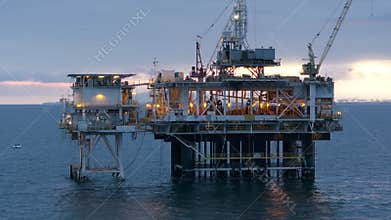 Offshore oil drilling rig and lots of ships on the horizon in the Pacific Ocean