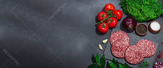 Raw burger patties. Fresh meat cutlets, spices, vegetables, herbs. Homemade American classic