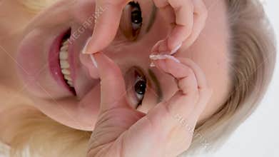vertical video woman on white shirt smile and hand gesture in heart shape showing love, support to medical staffs