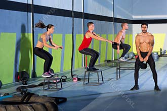 Crossfit box jump people group and kettlebell man