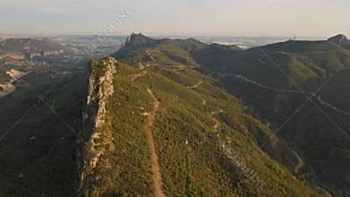 aerial scenic landscape with green fields, meadows, curved mountain river and mountain ridge with high mountains and