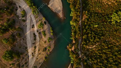 aerial scenic landscape with green fields, meadows, curved mountain river and mountain ridge with high mountains and