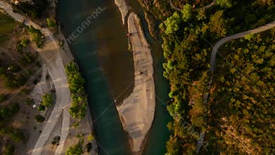 aerial scenic landscape with green fields, meadows, curved mountain river and mountain ridge with high mountains and