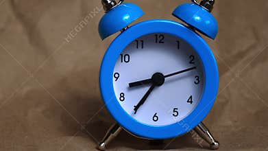 Hands of the Classic Alarm Clock Count the Time
