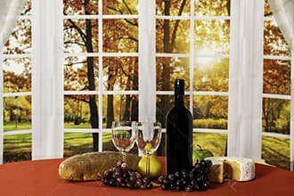 Autumn wine and cheese on red with fall window background