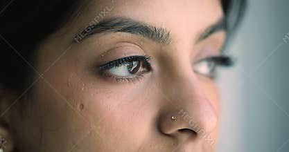 Closeup face view pensive serious Indian woman staring into distance