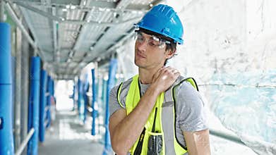 Young hispanic man architect suffering for cervical pain at construction place
