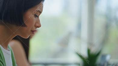 Asian woman sipping coffee at day office closeup. Programmers working computers