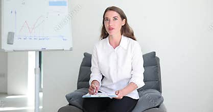 Woman teacher explains analytics to students or business partners